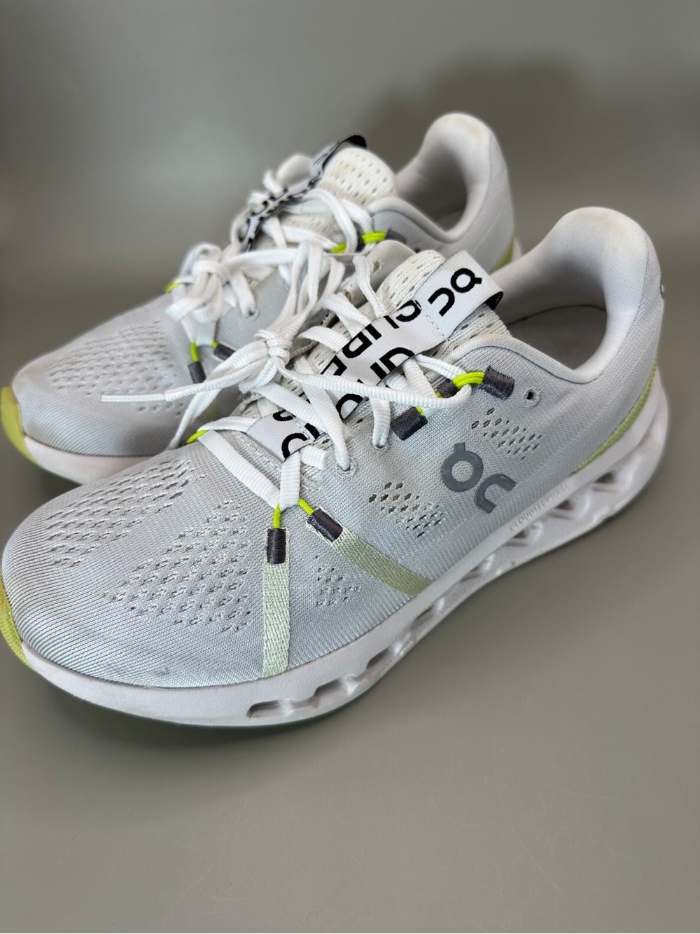 On Running White Athletic Shoes with Light Green Accents